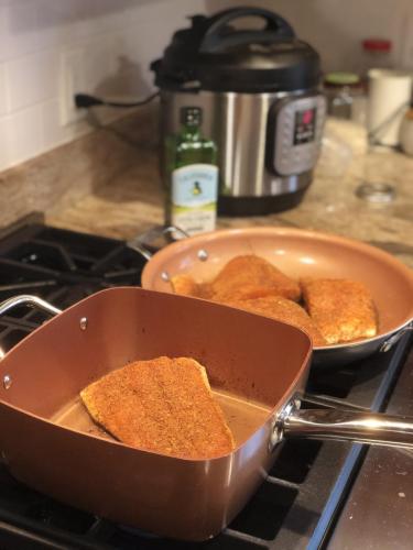 Salmon frying in copper pan